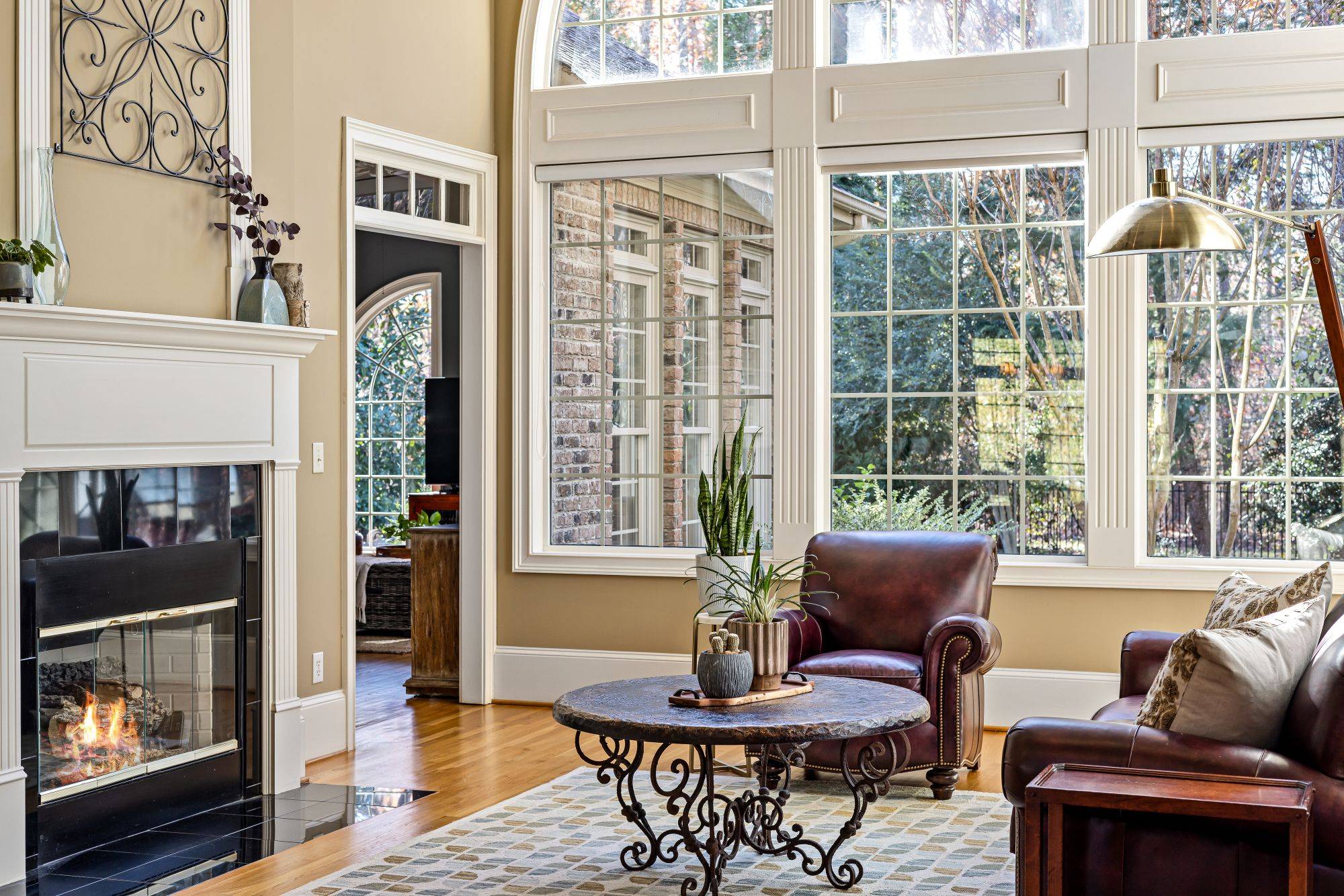 Two-story great room with tall windows and a fireplace